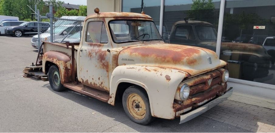 as he explored the outskirts of town, Joe stumbled upon a rusted and abandoned 1953 Ford pickup truck hidden in an overgrown field.