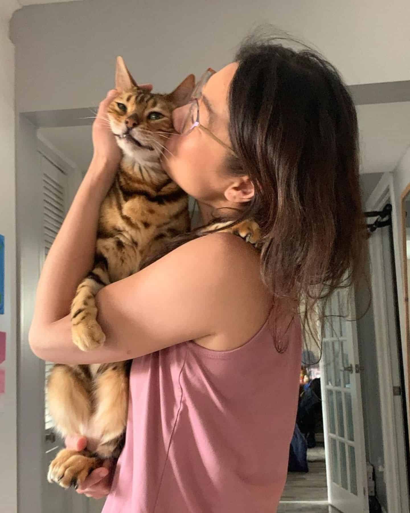 woman kissing a cat