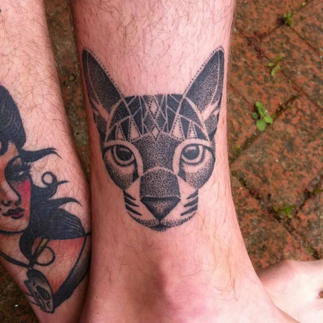 cat tattoo on a man's leg