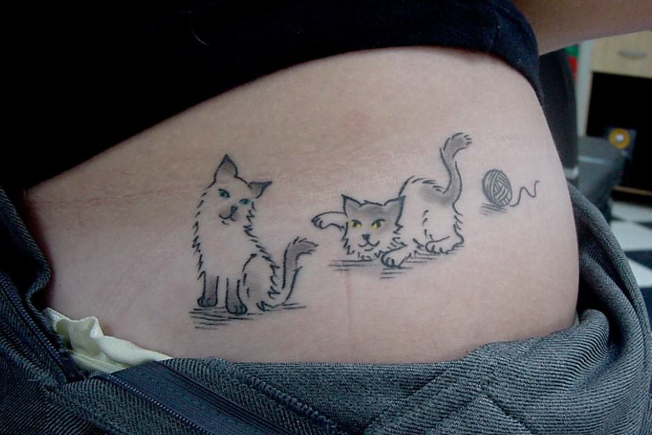 cat tattoo on woman's side