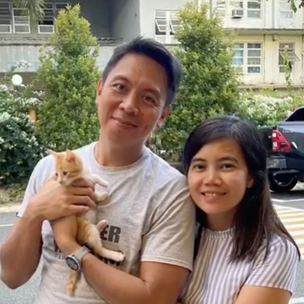 couple with happy kitten