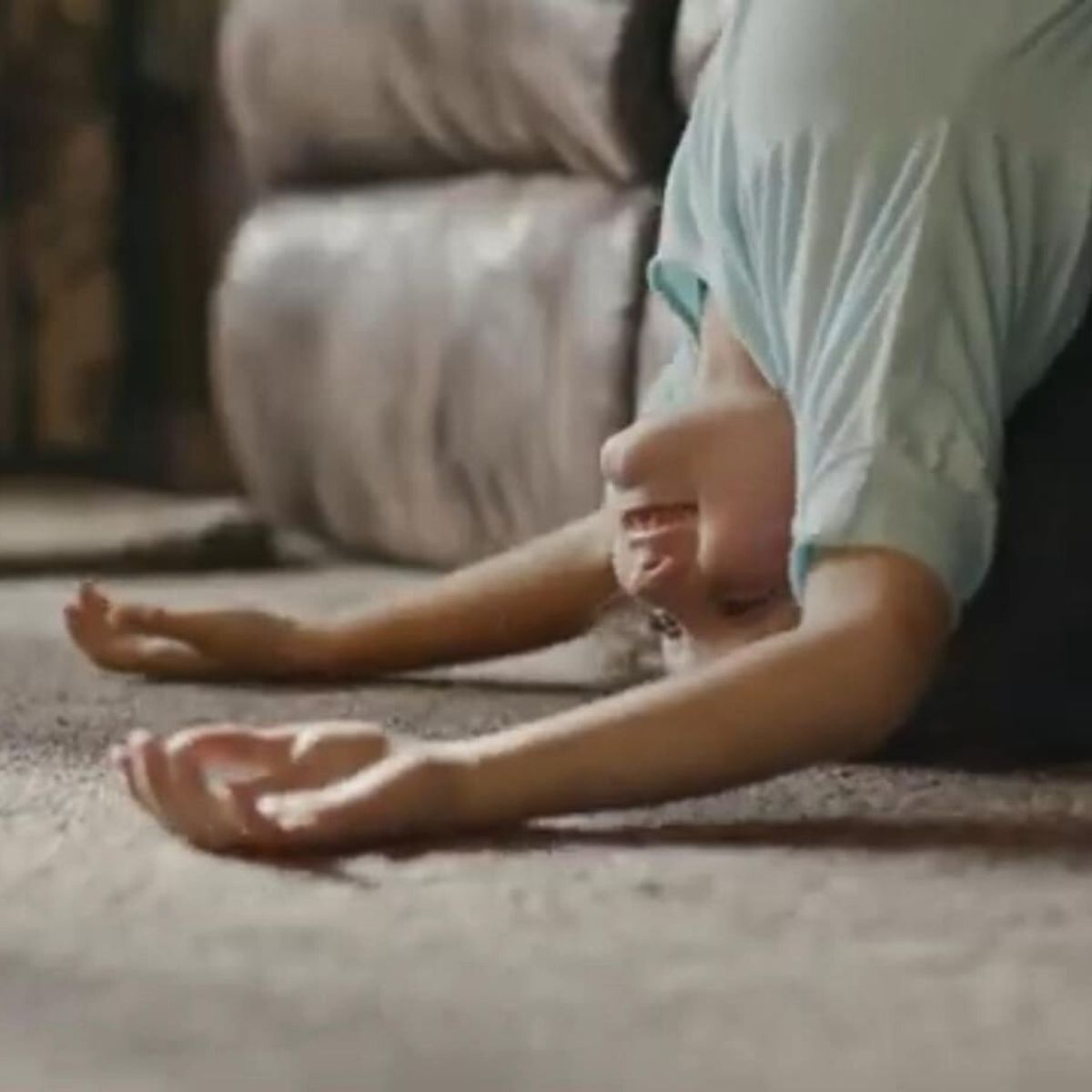 little girl leaning off the couch