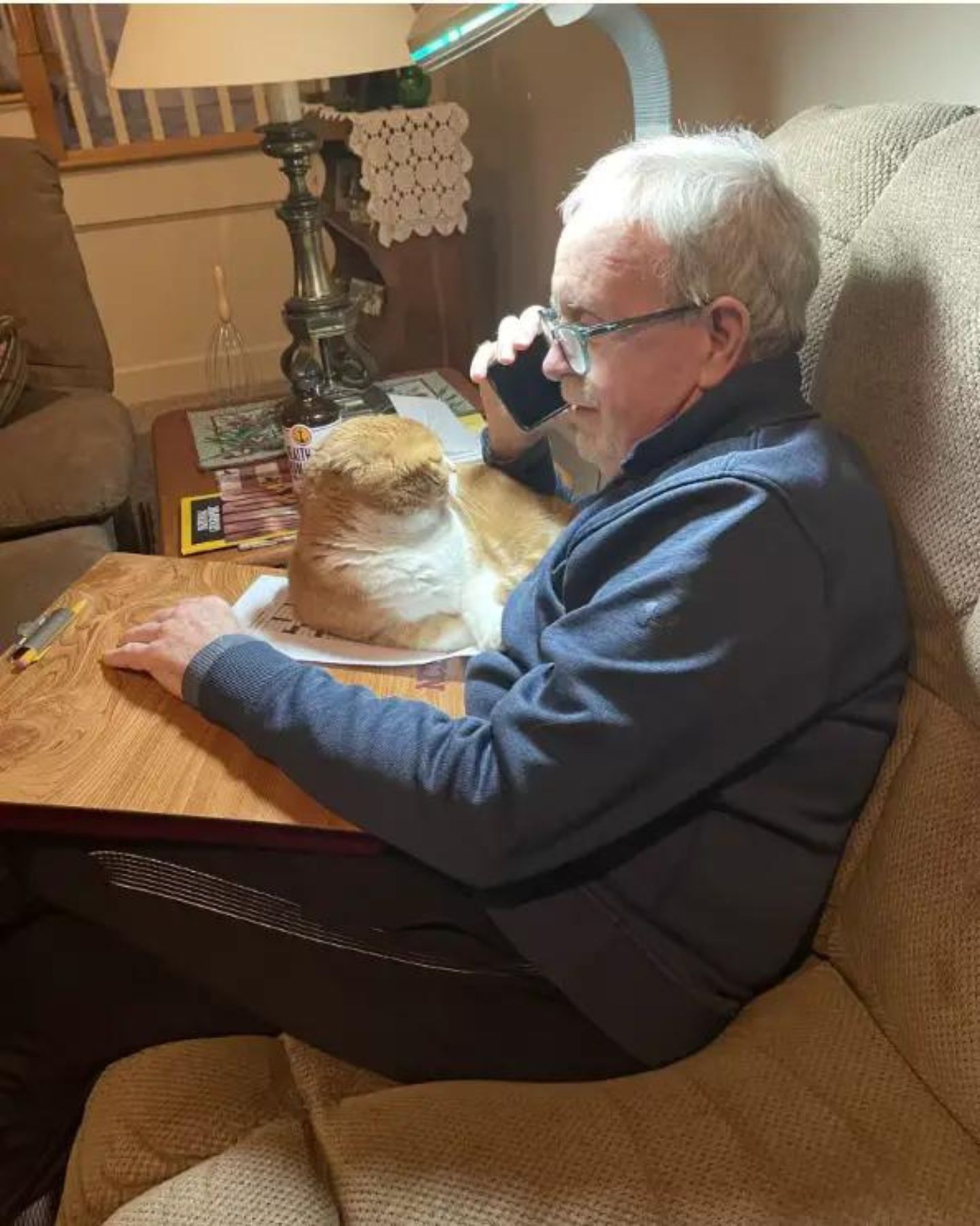 man and cat sitting on couch