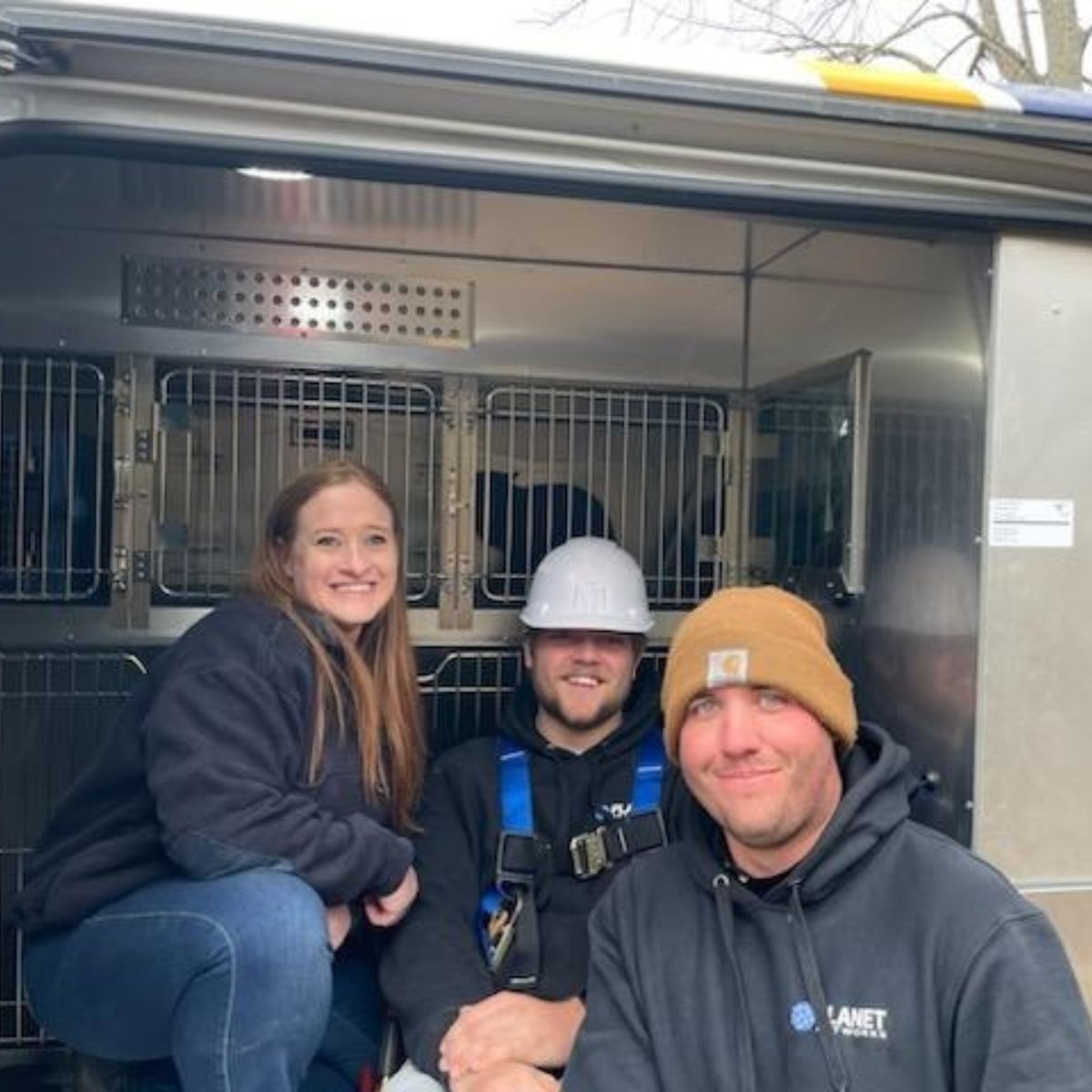 men and woman taking picture with cat