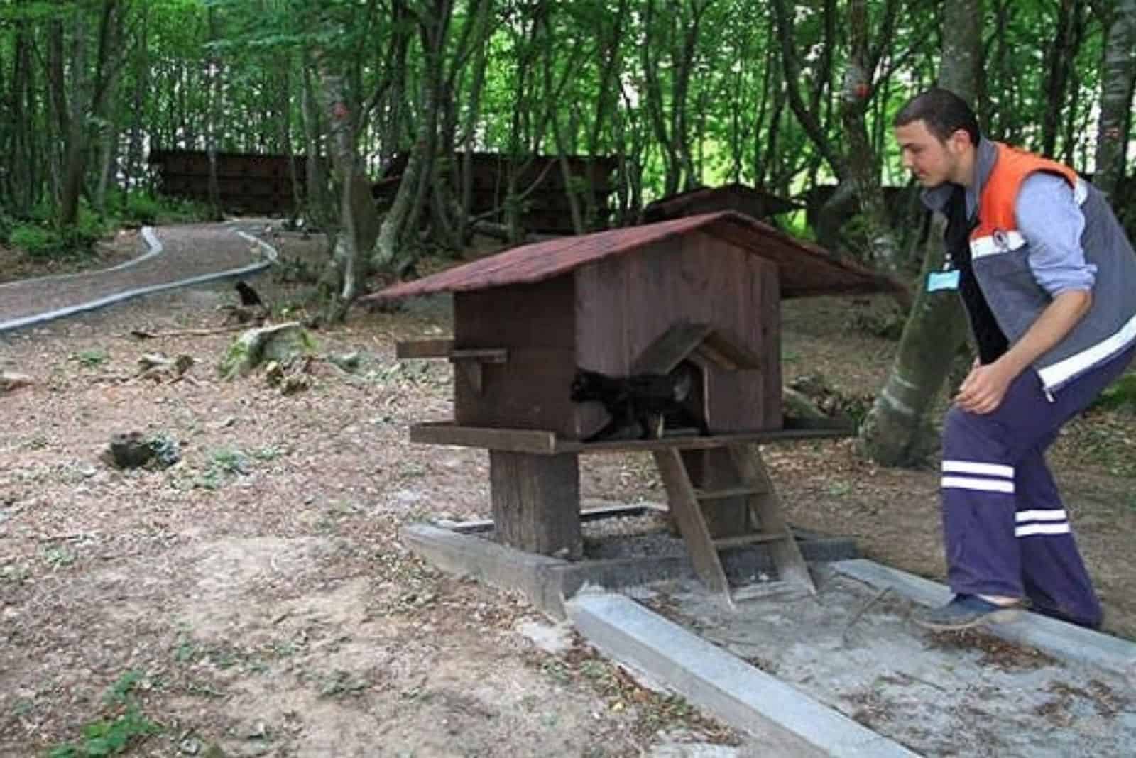 photo of a man and a black cat at the shelter