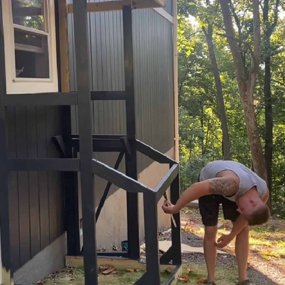 photo of a man building a catio