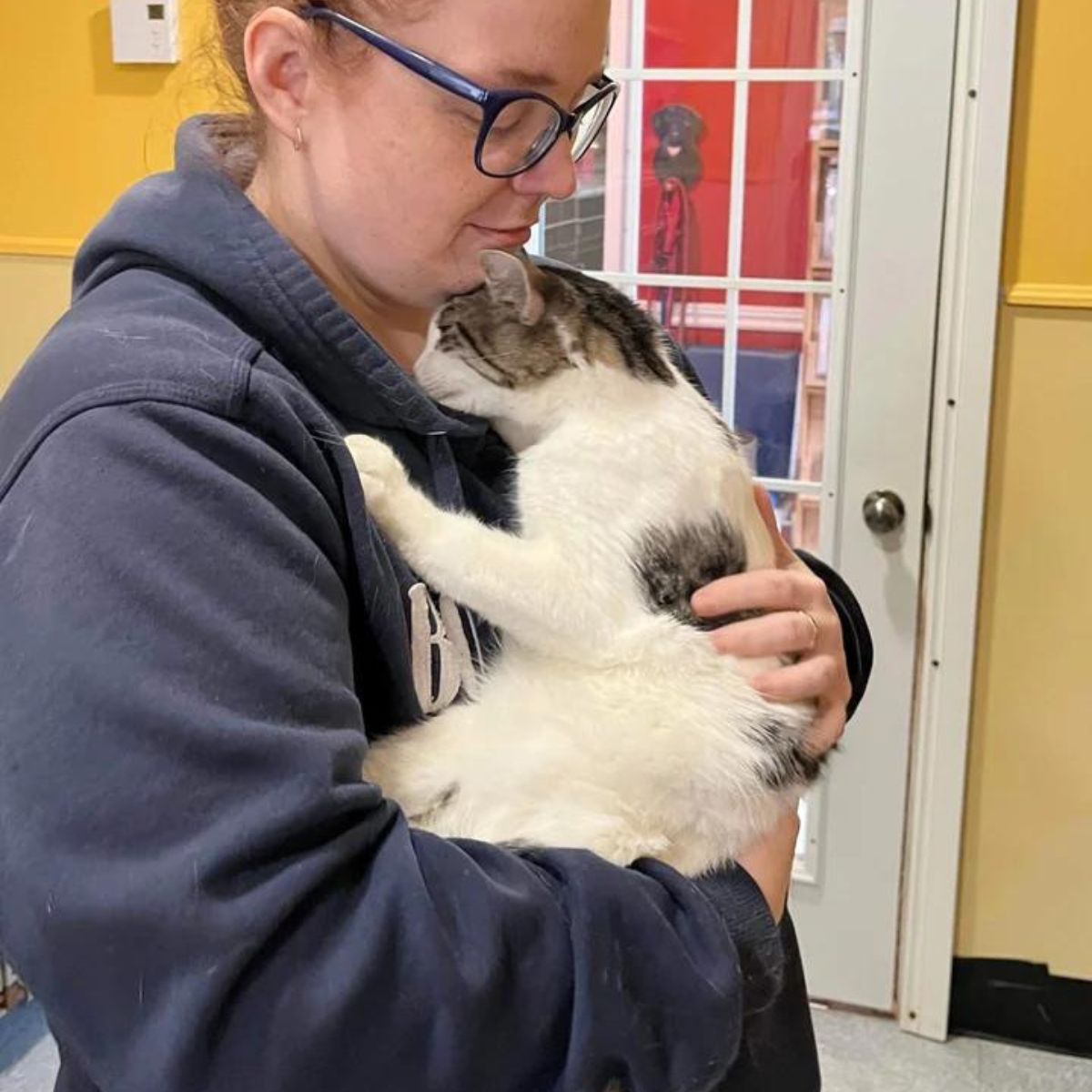 woman hodling cat at shelter
