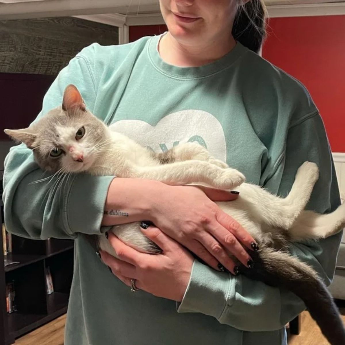 woman holding cat in arms