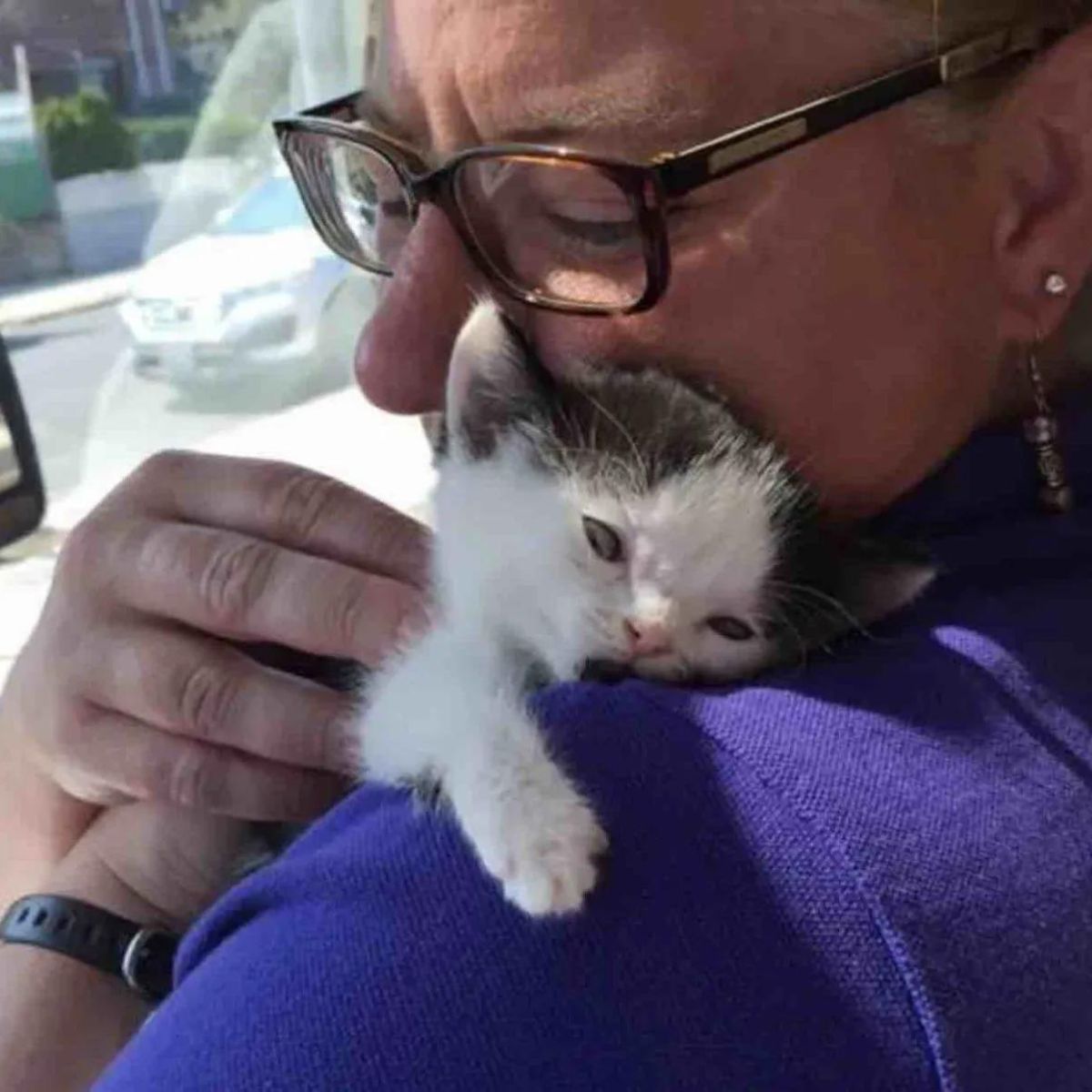 woman holding sick cat