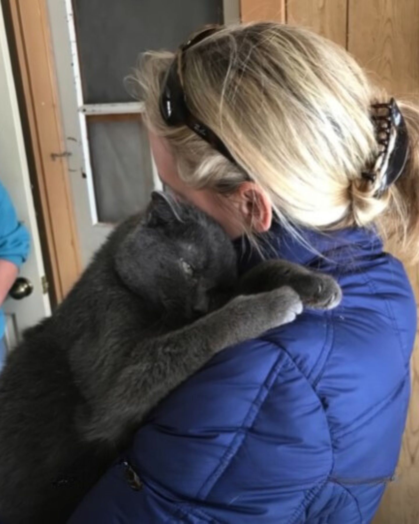 woman hugging cat with leukemia