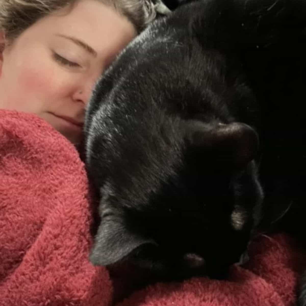 woman sleeping with cat