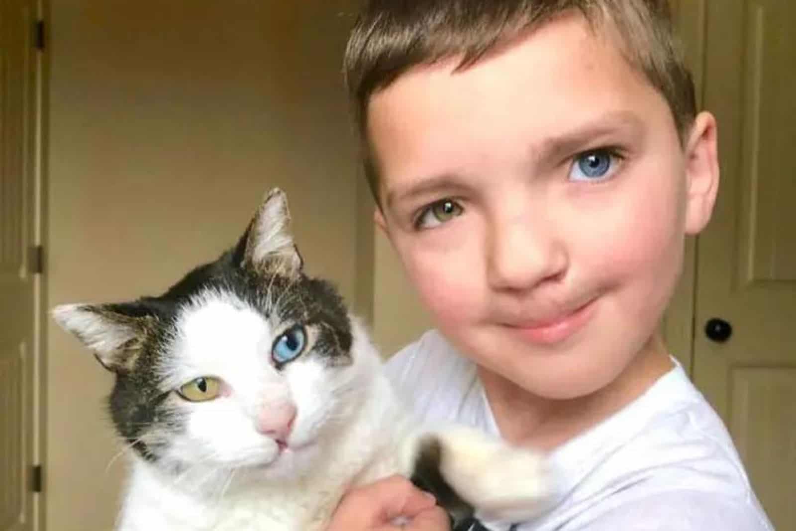 boy holding a cat