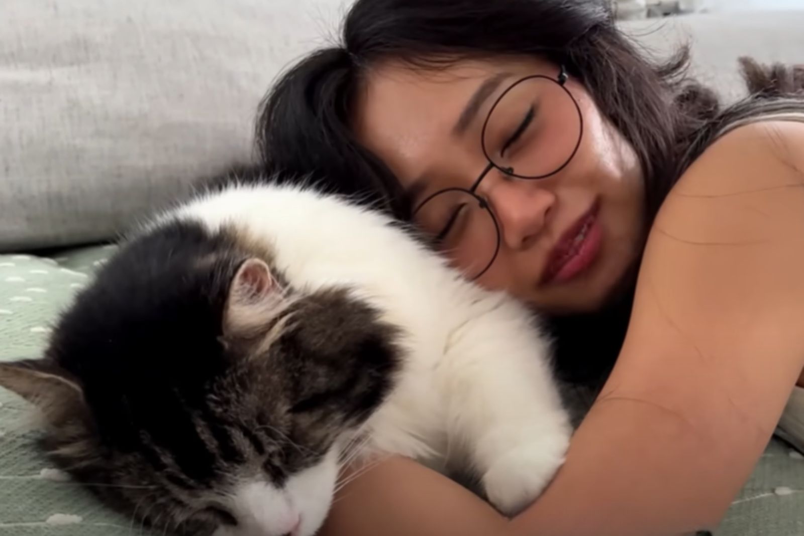 woman snuggling with kittem