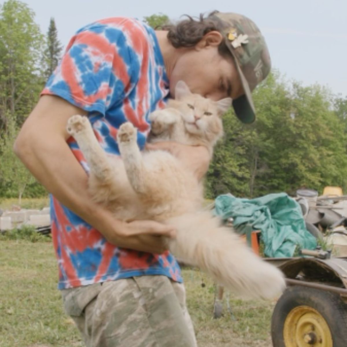 man holding and kissing the cat