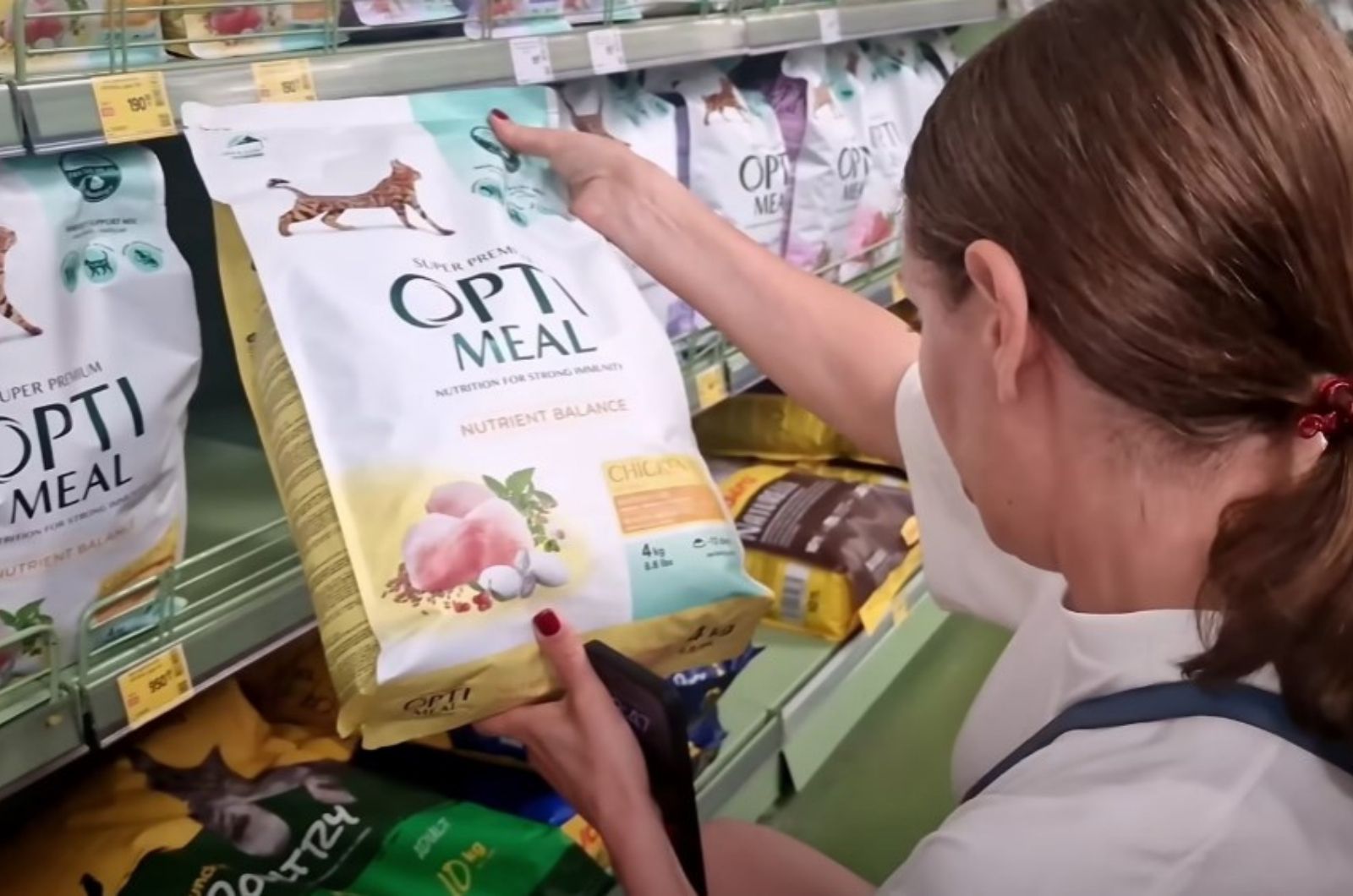 woman looking at cat food