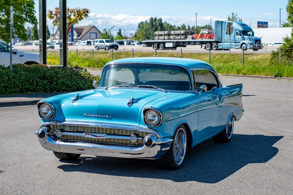 blue classic car parked on green grass field during daytime